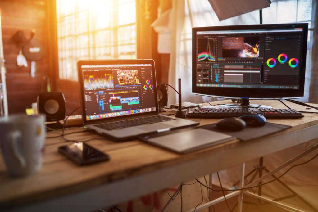 Freelance desktop with laptop computer and monitor review for editor work with content video
