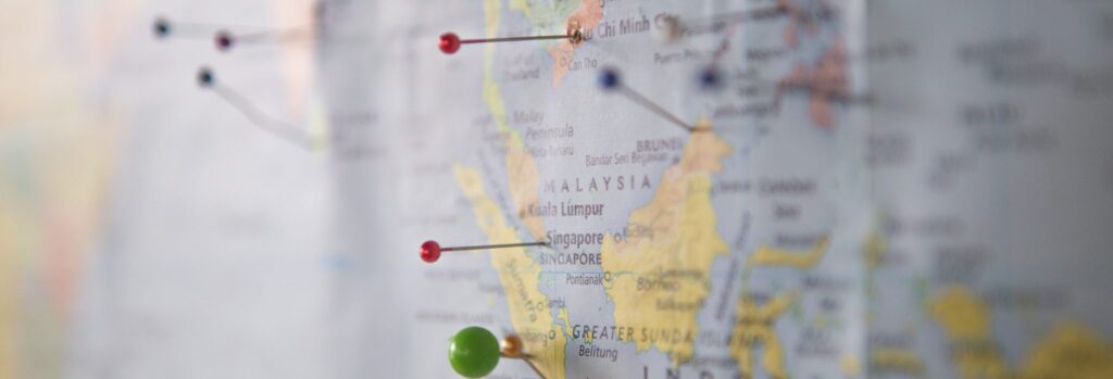Close up of multiple colored pins in a map of Malaysia