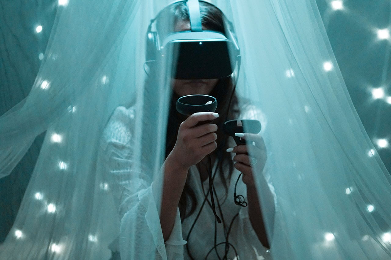 A women using a virtual reality headset and controllers