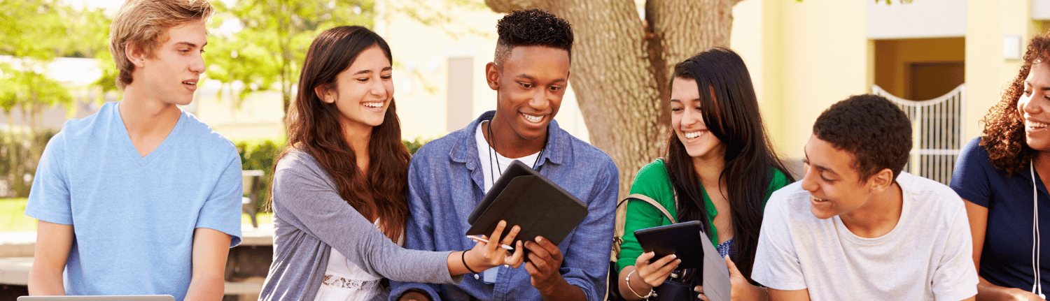 Group of young adults looking at tablet devices