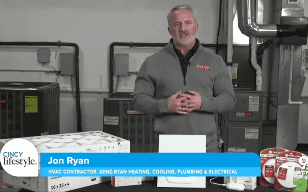 man talking in front of HVAC equipment
